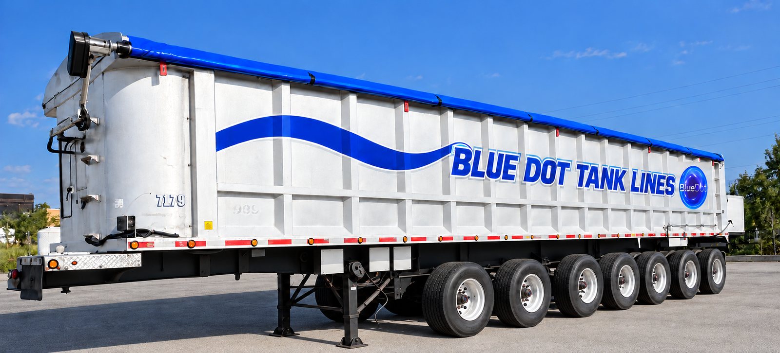 Blue Dot Tank Lines end dump trailer with blue tarp, side view