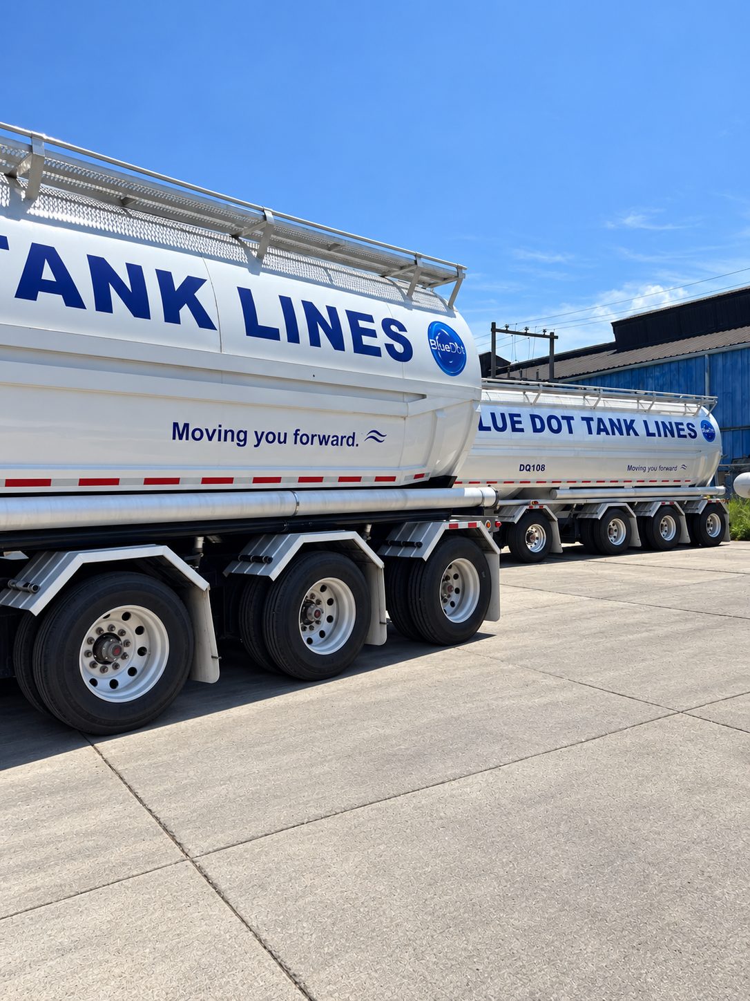 Close-up of a polished stainless Blue Dot food-grade tank trailer