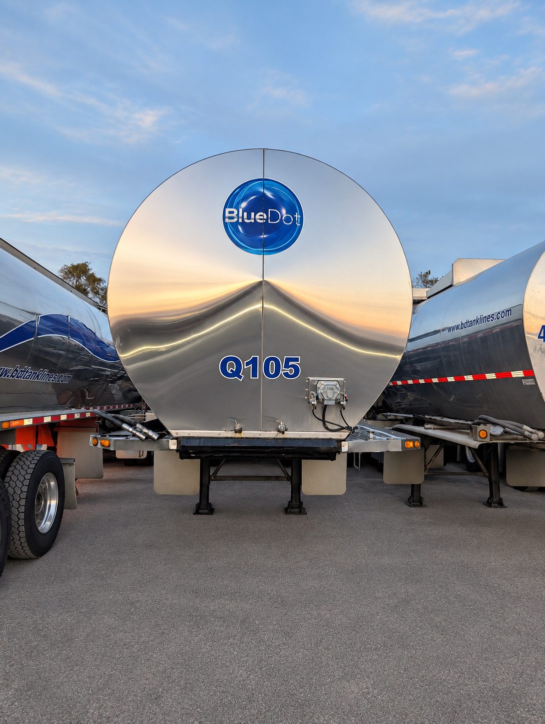 Rear of a polished stainless Blue Dot food-grade liquid tank trailer